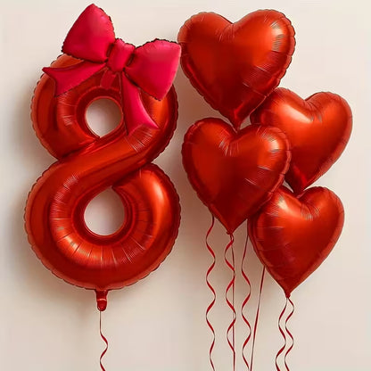 Red foil balloons including number 8 with pink bow and five heart-shaped balloons for birthday party decoration