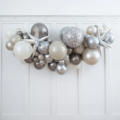 Metallic silver, pearl white, and gray balloon garland with star-shaped and disco ball balloons on white wall
