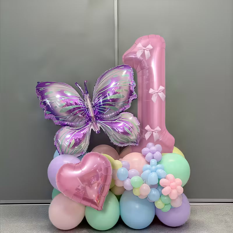 Light pink number 1 balloon with purple butterfly and heart-shaped foil balloons surrounded by pastel balloon bouquet