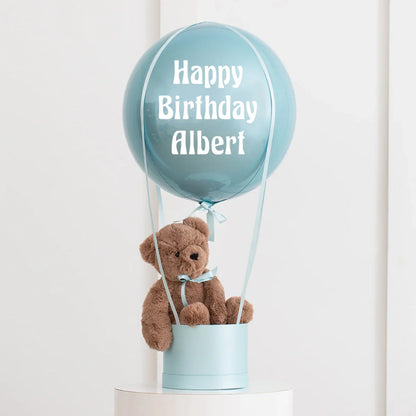 Personalized blue hot air balloon decoration with plush teddy bear and Happy Birthday Albert text