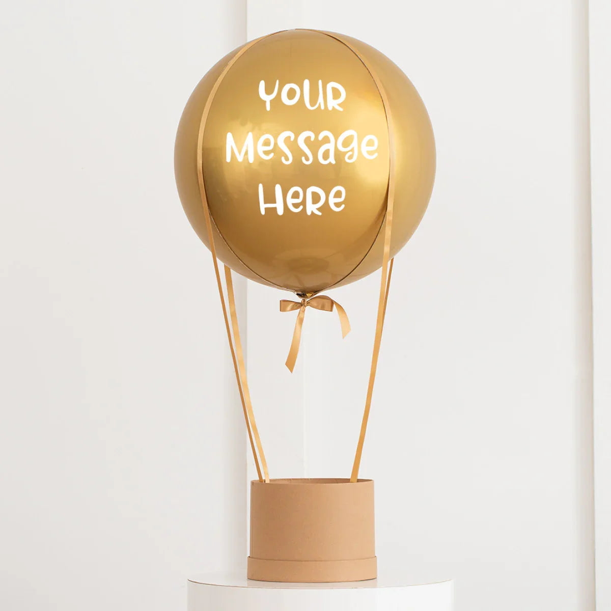 Gold hot air balloon decoration with ribbons and customizable message space on balloon