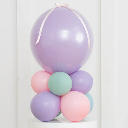 Pastel purple, pink, and teal balloon stack with large lavender air-filled bubble balloon on top