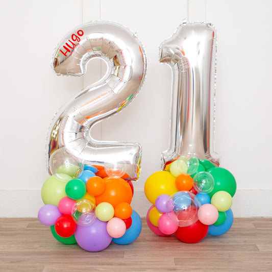 Personalized 26" Silver Foil Number Balloon on Colorful Rainbow Stack