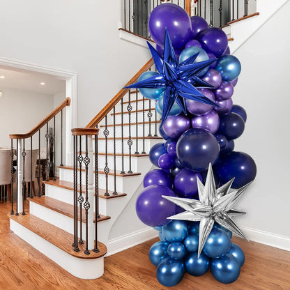 Cluster of blue and purple balloons with metallic star balloons decorating indoor wooden staircase