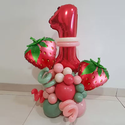 Red foil balloon shaped number 1 with strawberry-shaped balloons and pastel pink, green, and red latex balloons