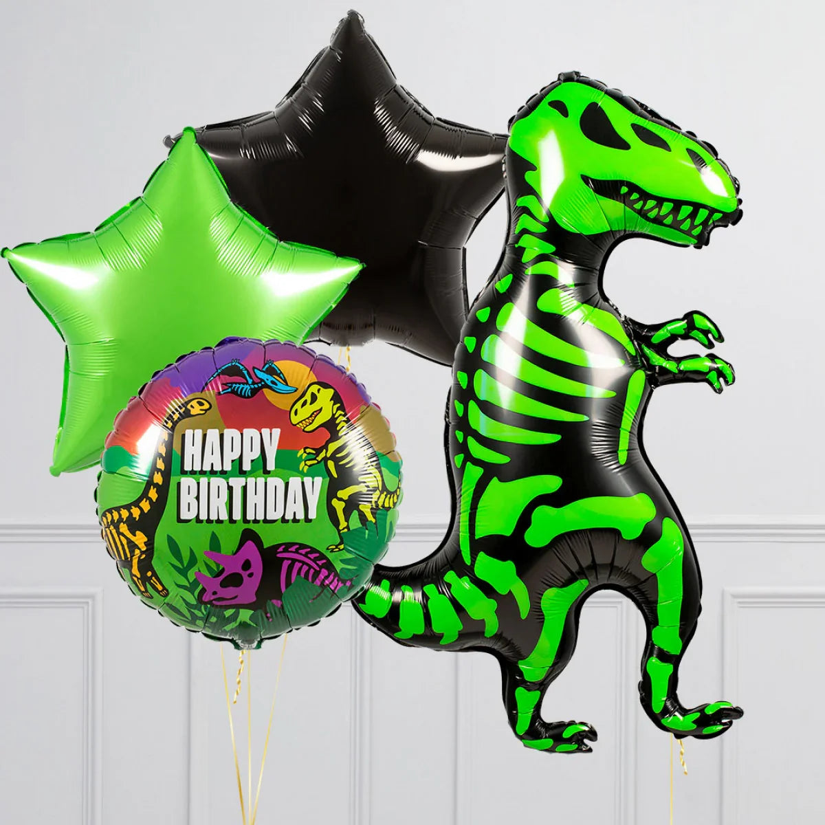 Black and green dinosaur skeleton balloon with green and black star balloons and a colorful happy birthday balloon