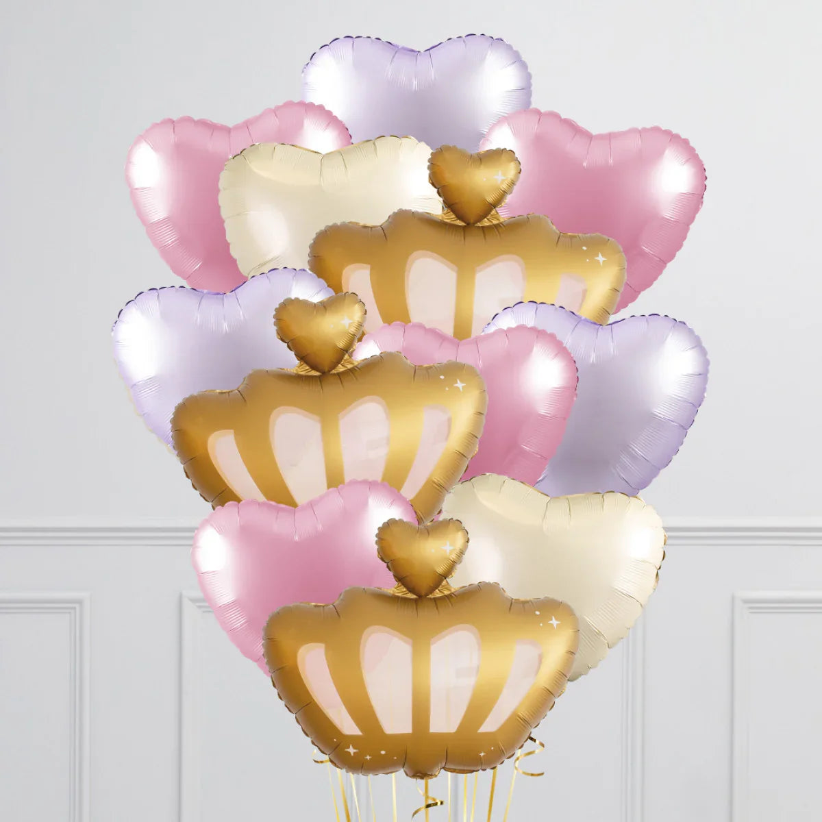 Cluster of gold crown and pastel heart-shaped foil balloons in pink, purple, and cream