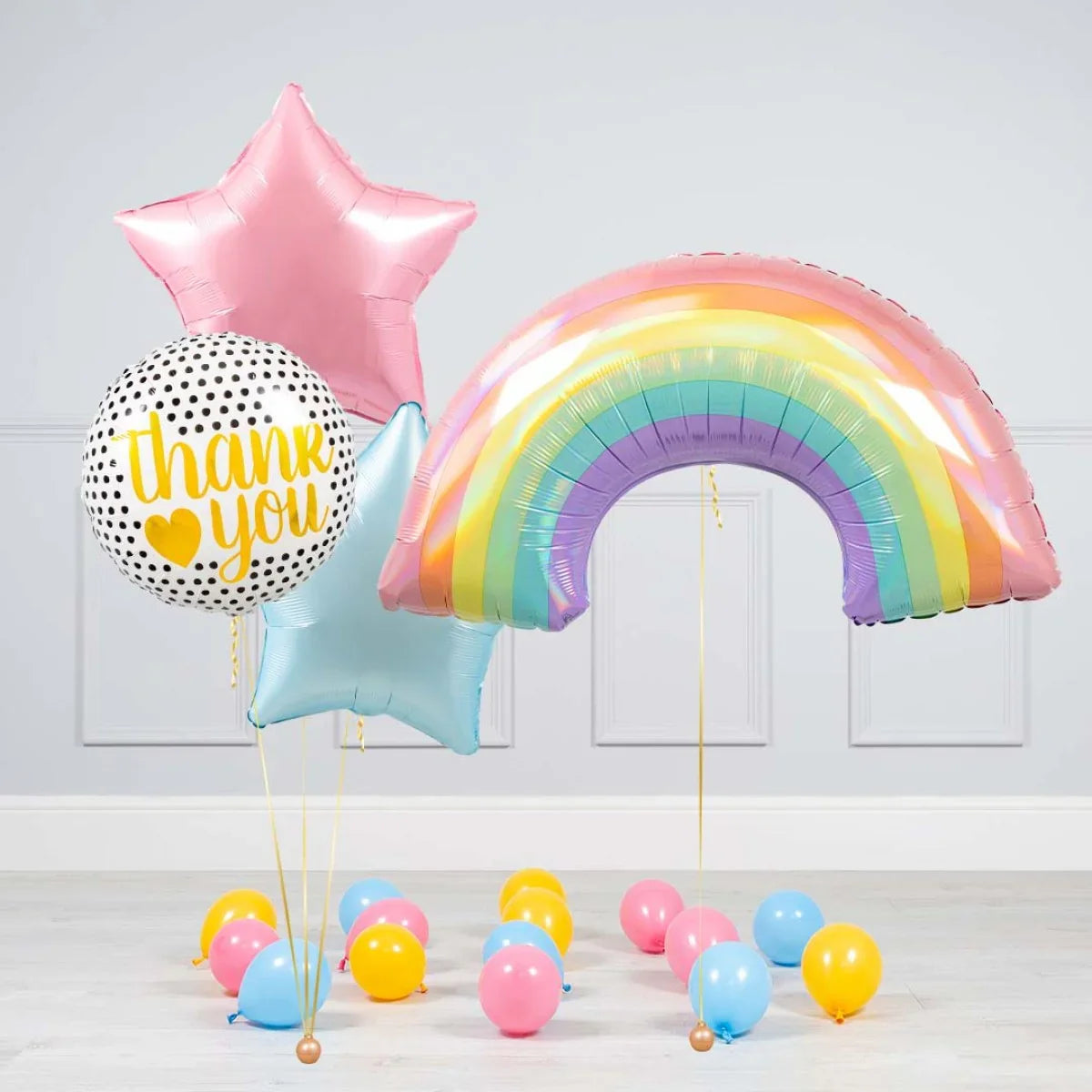 Colorful helium balloons including a rainbow, pink and blue stars, and a white polka dot balloon with 'thank you' text